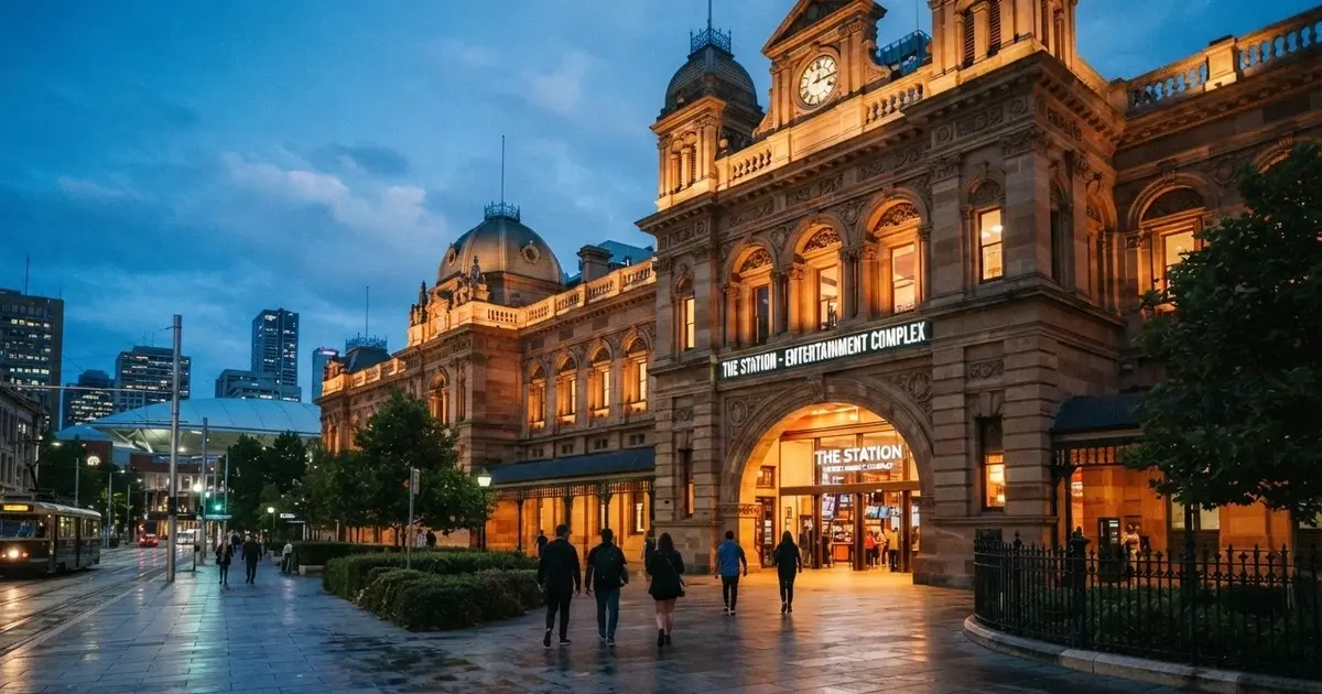 The heritage sandstone facade of SkyCity Adelaide on North Terrace at dusk, with the casino entrance and the former Railway Station architecture visible
